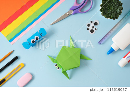 Desktop with handmade paper crafts turtle and fish and diy art supplies. Top view. Desktop with handmade paper crafts turtle and fish and diy art supplies. Top view. 118619087