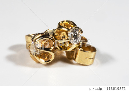 Diamond Earrings Isolated on White Background. Yellow Gold Diamond Earring Pair with 750 Stamp Denoting 18-Carat Yellow Gold. 118619871