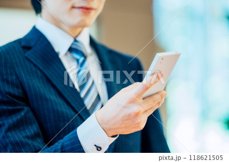 スマホを操作するビジネスマン　撮影協力：学校法人電波学園　東京電子専門学校 118621505