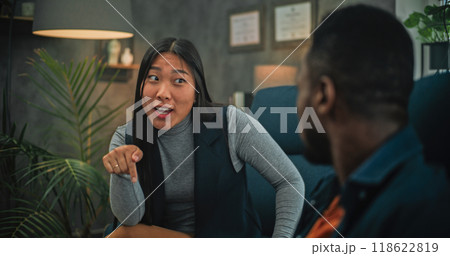 Close up of annoyed African American man listening his girlfriend during couples therapy 118622819