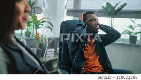 Aggressive man shouts at his girlfriend on counseling session with family psychotherapist Aggressive man shouts at his girlfriend on counseling session with family psychotherapist 118622868