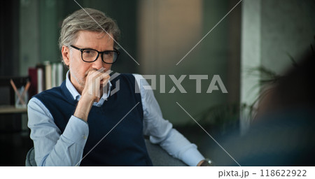 Mature psychologist analyzes problem, provides couples therapy Mature psychologist analyzes problem, provides couples therapy 118622922