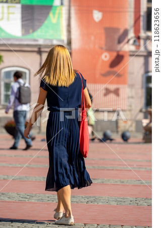 Woman walking on the street 118623656