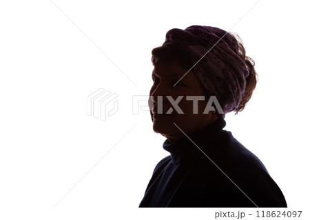 Dark silhouette of an elderly woman, pensioner in headdress - isolate 118624097