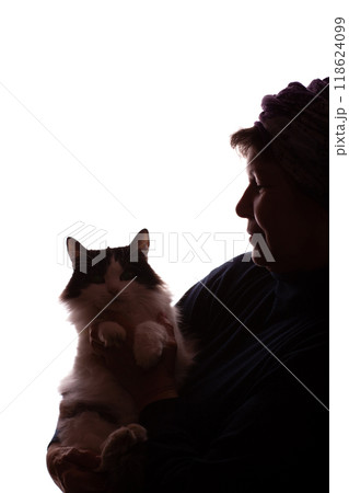Dark silhouette elderly woman, pensioner with cat in hands - isolate 118624099