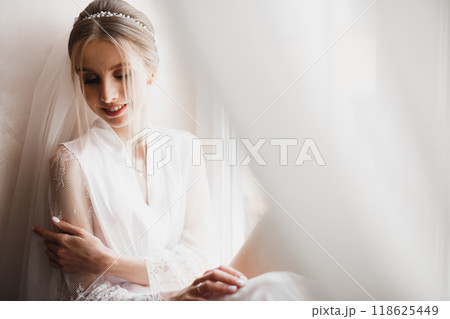 Luxury bride in white dress posing while preparing for the wedding ceremony Luxury bride in white dress posing while preparing for the wedding ceremony 118625449