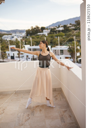An Elegant Dancer Posing Outdoors Against a Beautiful Scenic View and Breathtaking Landscape An Elegant Dancer Posing Outdoors Against a Beautiful Scenic View and Breathtaking Landscape 118625550