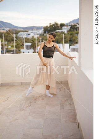 An Elegant Dance Pose Captured on a Beautiful and Scenic Terrace with Picturesque Views 118625666