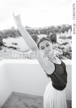 An Elegant Ballet Dance Pose captured beautifully in a Scenic Outdoor Setting amidst nature An Elegant Ballet Dance Pose captured beautifully in a Scenic Outdoor Setting amidst nature 118625678