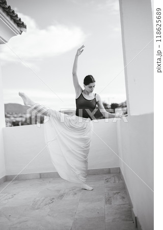 A Graceful Ballet Dancer is Posing Elegantly on a Beautiful Balcony with Scenic Views 118625689