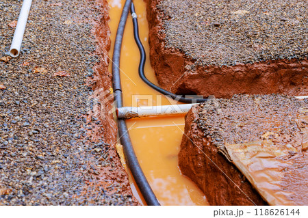 When it rains heavily, drainage trench for communication cable becomes flooded 118626144