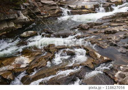 Mountain river with stones. Rafting river in forest. Splashy fast river texture. Natural water background 118627056