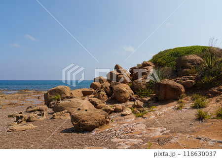 Rocky Mediterranean Coastline with Vegetation and Clear Sky Rocky Mediterranean Coastline with Vegetation and Clear Sky 118630037