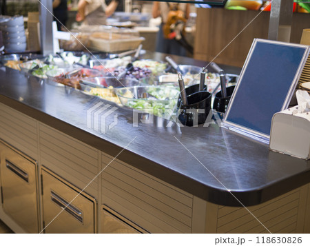 Empty food menu on dark background next to food in refrigerators ready to be filled with delicious options Food menu awaits creative dishes and enticing descriptions Food menu stands out in contrast 118630826