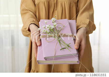 Aesthetics of books with flowers on a light background. Aesthetics of books with flowers on a light background. 118631331