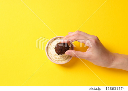 Falafel with sauce, on a bright, yellow background. 118631374