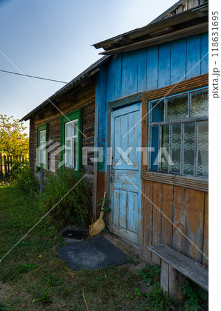 An old, rustic house in the evening in the village. Old Slavonic House An old, rustic house in the evening in the village. Old Slavonic House 118631695