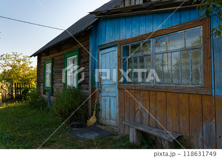An old, rustic house in the evening in the village. Old Slavonic House An old, rustic house in the evening in the village. Old Slavonic House 118631749