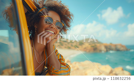 Young woman taking photo, enjoying summer travel, upper body out of car window, high resolution image 118632256