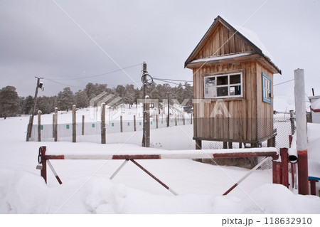 A small, cozy wooden house in nature in the winter park 118632910
