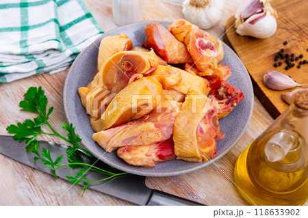 Uncooked chicken and condiments on kitchen table 118633902