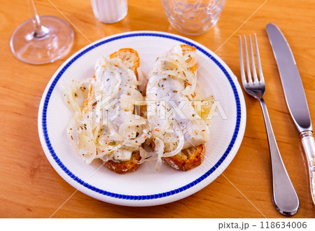 Marinated herring and onion sandwich served on plate 118634006