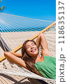 Beach vacation travel woman happy sleeping in hammock at holiday resort - Caribbean travel holidays Asian girl lying down relaxing outdoors sunbathing. 118635137