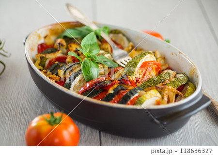 prepared baked zucchini and tomatoes in circles in a ceramic form, vegetable snack prepared baked zucchini and tomatoes in circles in a ceramic form, vegetable snack 118636327