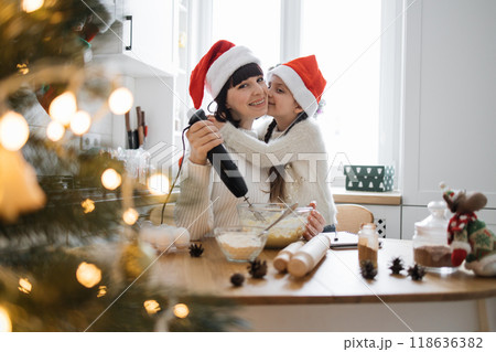Mother and daughter baking together during Christmas season Mother and daughter baking together during Christmas season 118636382
