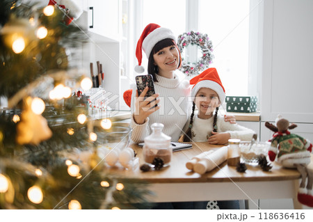 Mother and daughter baking together during Christmas holidays 118636416