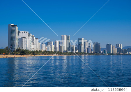 Panorama of the resort of Nha Trang city in Vietnam with a sandy beach by sea and skyscrapers of hotels in summer Panorama of the resort of Nha Trang city in Vietnam with a sandy beach by sea and skyscrapers of hotels in summer 118636664