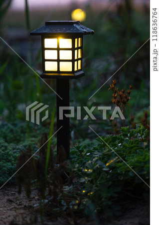 Solar-powered lanterns for flower beds in the yard of the house for decorative street lighting and landscaping Solar-powered lanterns for flower beds in the yard of the house for decorative street lighting and landscaping 118636764