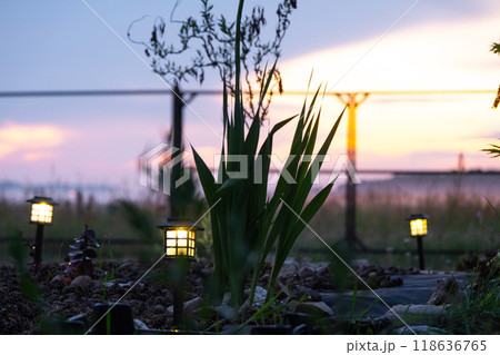 Solar-powered lanterns for flower beds in the yard of the house for decorative street lighting and landscaping Solar-powered lanterns for flower beds in the yard of the house for decorative street lighting and landscaping 118636765