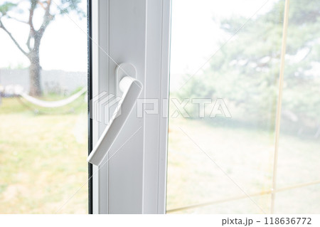Window from inside the house plastic double-glazed window view outside to the sunny forest - interior salon with potted plants, clean glass after cleaning windows, closed window Window from inside the house plastic double-glazed window view outside to the sunny forest - interior salon with potted plants, clean glass after cleaning windows, closed window 118636772