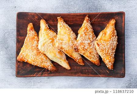 Homemade triangle puff pastry with meat on rustic background . Samosa 118637210