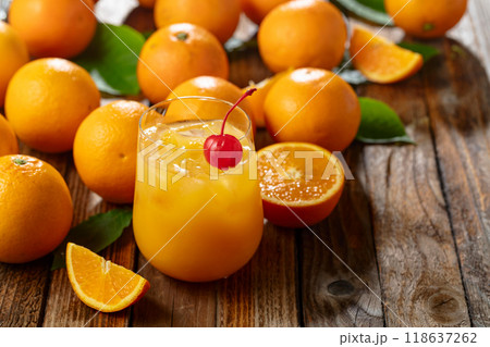Orange juice and fresh fruits on an old wooden table. Orange juice and fresh fruits on an old wooden table. 118637262