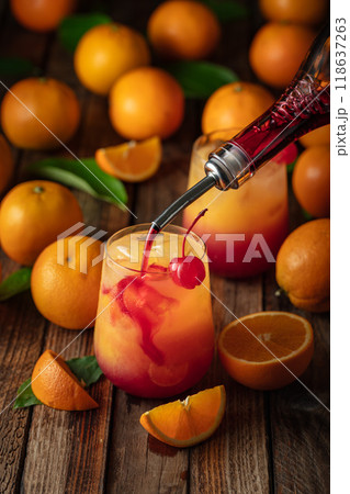 Classic tequila sunrise cocktail on an old wooden table. 118637263