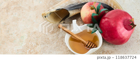 Rosh Hashanah Symbols. Traditional items for Rosh Hashanah shofar, honey, apple, and pomegranate on a rustic background. Rosh Hashanah Symbols. Traditional items for Rosh Hashanah shofar, honey, apple, and pomegranate on a rustic background. 118637724
