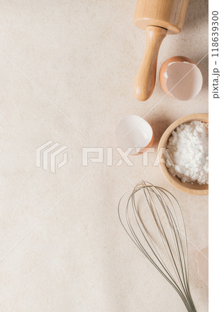 Baking flour and baking supplies placed on a beige tabletop with copy space and vertical photography. 118639300