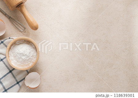 Baking flour and baking supplies placed on a beige tabletop with copy space and horizontal photography. 118639301