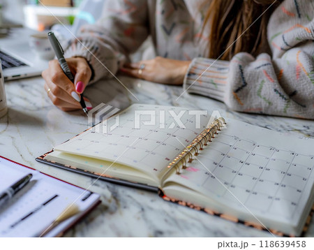 High resolution image of someone planning their week with a calendar, focusing on balanced and productive schedule, High resolution image of someone planning their week with a calendar, focusing on balanced and productive schedule, 118639458