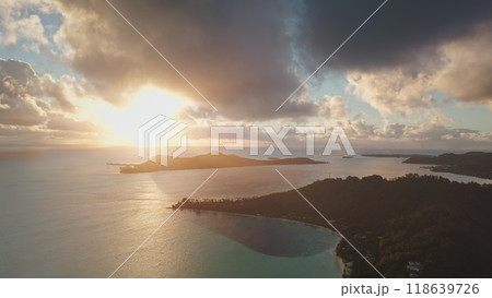 Bora Bora island with turquoise lagoon, mountains and clouds reflecting golden light of amazing colorful sunrise. Tropical island, beautiful landscape of untouched nature. Travel. Aerial drone flight Bora Bora island with turquoise lagoon, mountains and clouds reflecting golden light of amazing colorful sunrise. Tropical island, beautiful landscape of untouched nature. Travel. Aerial drone flight 118639726