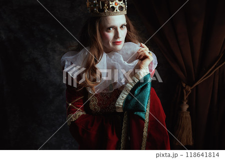 medieval queen in red dress with white collar and crown 118641814