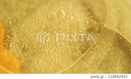 Oil bubbles. Golden ink. Defocused yellow color translucent sparkling paint shiny sequin particles gel flow motion abstract art background. 118642642