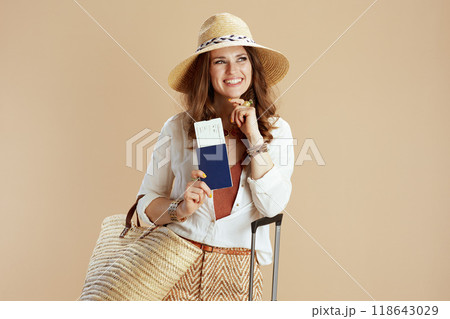 happy elegant 40 years old woman in blouse and shorts on beige 118643029