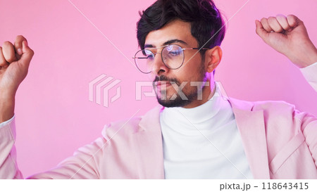 Winner dance. Victory inspiration. Neon light relaxed satisfied business man in glasses suit celebrating success isolated on pink copy space background. Winner dance. Victory inspiration. Neon light relaxed satisfied business man in glasses suit celebrating success isolated on pink copy space background. 118643415