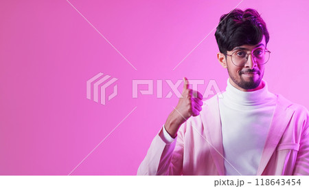 Man choice. Positive feedback. Purple neon color light impressed smart guy recommending with thumb up isolated on pink empty space advertising background. 118643454