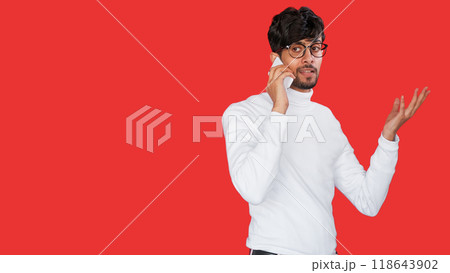 Mobile negotiation. Business call. Modern communication technology. Excited curious man speaking on phone isolated on red empty space background. 118643902
