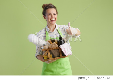 happy modern housewife showing thumbs up isolated on green happy modern housewife showing thumbs up isolated on green 118643958