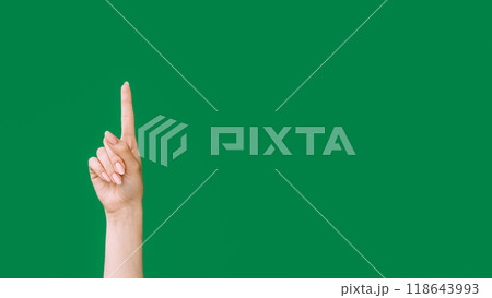 Pointing up. Idea gesture. Look here. Female hand index finger showing insight isolated on green empty space advertising background. 118643993